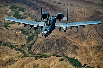 Gray Jet Fighter, Brown Mountain, military aircraft, desert landscape, dramatic views, flying above, vast desert, mountainous terrain, aerial view, combat plane, military jet