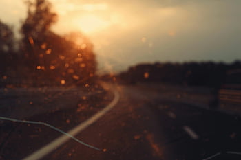 road, sunset, blurry, car windshield, dreamy effect, road photo, evening drive, bokeh, travel photography, scenic route, golden hour