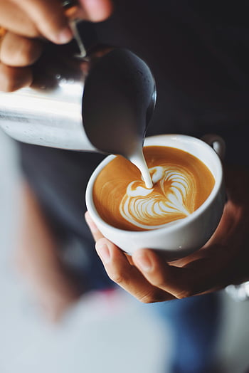 woman pouring cappuccino, latte art, barista, coffee shop, pouring milk, coffee cup, close-up, stunning latte art, coffee preparation, barista skills, coffee artistry