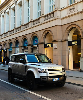 Luxury Land Rover Defender, Milan, luxury shops, silver Land Rover, Fendi, Italy, urban street, high-end vehicle, modern SUV, cityscape, European fashion