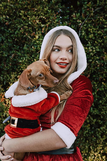 Santa outfit, dog Santa costume, festive season, outdoors, woman and dog, Christmas costumes, holiday spirit, pet and owner, red and white, holiday photoshoot, festive attire