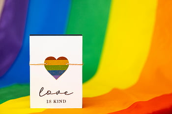 LGBT love, rainbow flag, love is kind, rainbow heart, vibrant background, pride card, LGBTQ+ slogan, rainbow colors, love card, pride month, LGBTQ+ pride