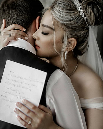 newly married couple, bride and groom, intimate embrace, wedding elegance, romantic couple, wedding day, wedding attire, wedding photo, couple hugging, wedding vows, handwritten letter