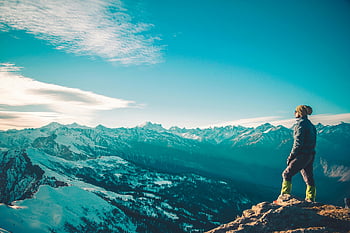 man on mountain, Himalayan peak, snowy landscape, blue sky, winter scene, mountain top, outdoor adventure, scenic view, alpine scenery, high altitude, nature photography