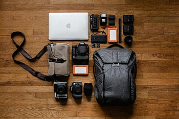 camera equipment, laptop, hardwood floor, photography setup, top view, photo gadgets, high-angle shot, camera lenses, camera bag, flash units, memory cards