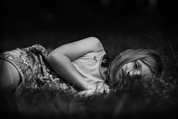 girl, sad, monochrome, lying, meadow, grass, child, young, woman, female, person