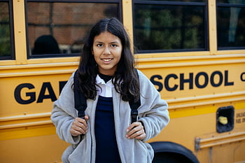 Happy Hispanic girl, school bus, backpack, smiling, ready for school, yellow school bus, Hispanic student, school day, education, school transportation, school readiness