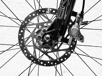 bicycle spokes, black and white photo, disc brakes, bicycle wheel, detailed image, bike components, monochrome photography, cycling equipment, close-up shot, bike parts, bicycle disc brakes