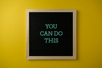 motivational slogan, framed board, yellow wall, inspirational message, You Can Do This, blackboard, bold yellow backdrop, motivational quote, inspirational quote, yellow background, framed message