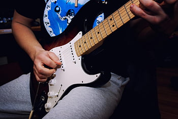 man performing guitar, electric guitar, musician strumming, focused hands, rock music vibes, guitar playing, electric guitar player, music performance, guitar performance, rock musician, guitar strumming