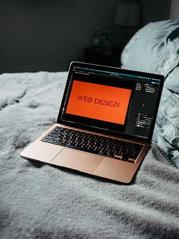 laptop, web design, development, bed, cozy workspace, software, screen, keyboard, orange background, text, technology