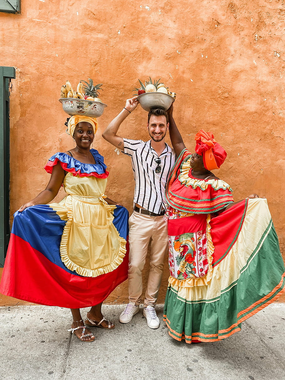 traditional dress, fruit vendors, tourist, Cartagena, Colombia, colorful dresses, Colombian culture, street photography, cultural experience, local traditions, vibrant colors