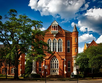 Clark Hall, University of Alabama, brick facade, iconic building, red and white, painted building, campus architecture, historic structure, academic building, university landmark, gothic windows
