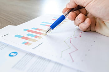 close-up photo, survey spreadsheet, hand with pen, analyzing data, colorful bar charts, line charts, paper, business analysis, financial data, chart analysis, pen pointing