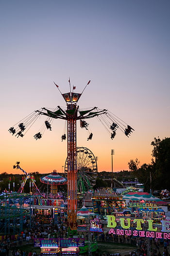 fair at sunset, colorful fairground rides, attractions at sunset, Boise ID, lively atmosphere, exciting atmosphere, fairground attractions, sunset fair, amusement park rides, fairground sunset, Boise fair