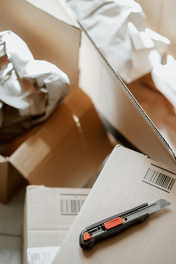 cardboard boxes, utility knife, packing paper, moving, storage, open boxes, cutting tool, household items, unpacking, barcodes, moving supplies