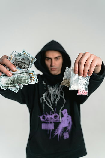 illegal-drugs-trade-man-in-hoodie-cash-d