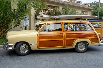 classic woody, station wagon, vintage surfboard, parked outdoors, brown and beige, surfboard on roof, classic car, woody station wagon, vintage car, outdoor parking, surf culture