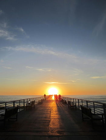 sunset, silhouette photography, people on dock, vibrant sky, ocean view, pier, walking, sunset photography, seaside, evening, benches