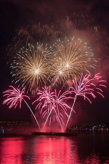 fireworks display, night time, Vancouver waterfront, colorful lights, majestic fireworks, serene waterfront, night celebration, fireworks over water, vibrant fireworks, nighttime fireworks, waterfront fireworks