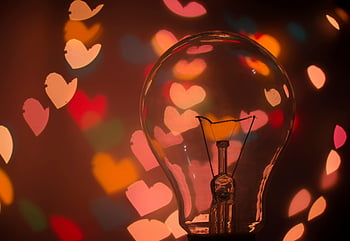 macro shot, light bulb, heart-shaped bokeh, colorful bokeh, warm mood, romantic mood, heart lights, bokeh effect, close-up photography, romantic lighting, heart-shaped lights