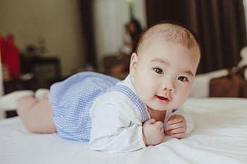 happy baby, baby on bed, morning baby, cute baby, blue checkered outfit, smiling baby, cozy bed, indoor baby photo, baby indoors, baby lying down, baby in morning
