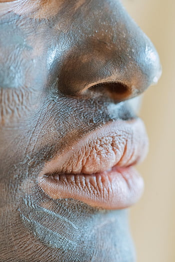 black woman, cosmetic mask, skincare treatment, clay mask, detailed close-up, texture, wellness routine, facial mask, beauty routine, skin care, close-up photo