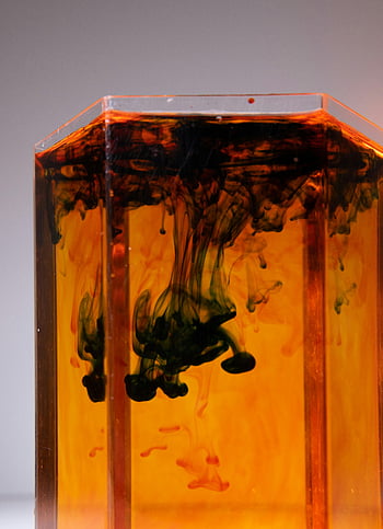 fluid dynamics, acrylic container, diffusing pigment, colorful fluid, abstract visual, transparent container, water flow, pigment flow, captivating visual, orange fluid, black pigment