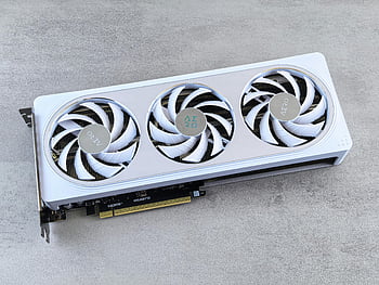 white gaming graphics card, triple fan graphics card, stylish graphics card, tech enthusiast product, neutral background, GPU with cooling fans, gaming hardware, white color graphics card, three cooling fans