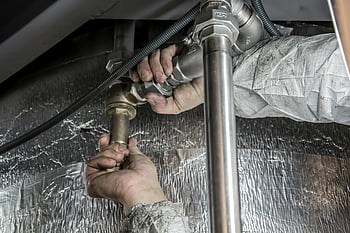 plumber, pipe fittings, steel pipes, indoor plumbing, skilled manual work, close-up hands, plumbing installation, indoor plumbing work, pipe installation, plumbing services, plumbing repair