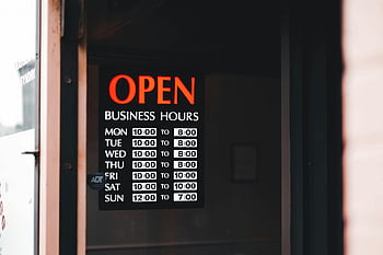 open business hours, shop window, close-up sign, business signage, operating hours, store hours, open sign, business hours display, shop hours, storefront sign, business hours board