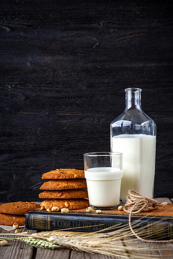 milk bottle, cookies, glass of milk, stack of cookies, rustic wooden table, book, bottle, milk and cookies, rustic setting, wooden background, milk bottle beside cookies