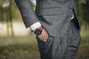 man wearing watch, hand on pocket, tailored suit, elegant wristwatch, outdoors, fashion, sophistication, close-up, stylish outfit, formal attire, nature background