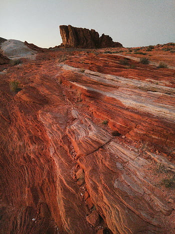 Valley of Fire, Nevada desert, red rock formations, dramatic landscape, gray sky, natural beauty, outdoor scenery, geological features, state park, scenic views, desert environment