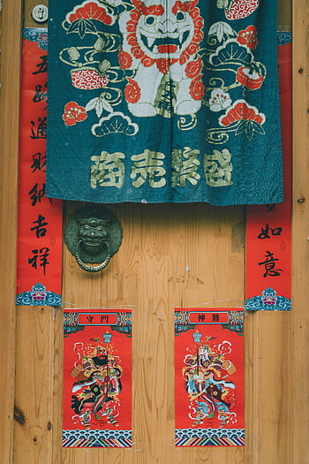 Chinese door, festive textiles, vibrant colors, decorated door, Chinese decorations, door knocker, red banners, cultural decor, traditional textiles, lion dance, Chinese calligraphy
