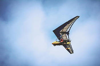 powered hang glider, yellow and black plane, blue sky, pilot on board, soaring, clear sky, aviation, outdoor activity, adventure sport, flight, clouds