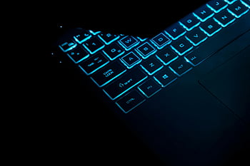 illuminated laptop keyboard, glowing keys, sleek design, close-up, dark background, laptop, keyboard, illuminated keys, technology, modern design, blue light