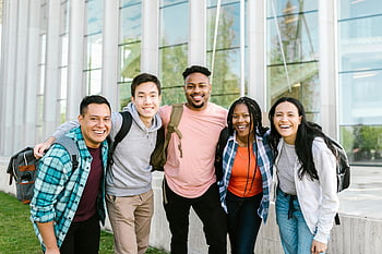 college students, standing together, diverse group, young adults, smiling, modern glass building, campus life, student group, outdoor photo, educational setting, friendship