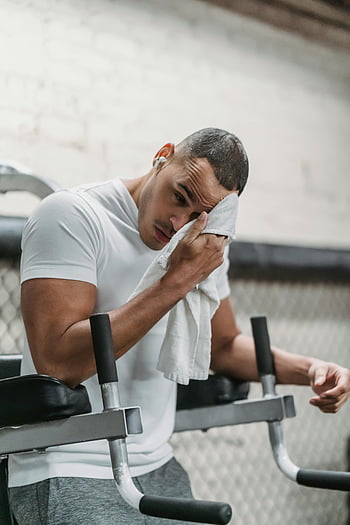 black man, gym workout, wiping forehead, towel, athletic man, intense workout, gym break, focus, young man, fitness, exercise