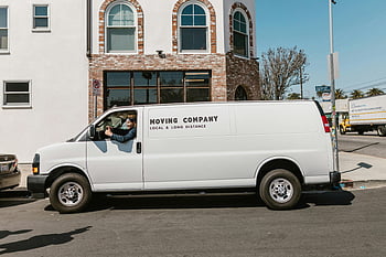 moving company van, parked car, city street, sunny day, local services, long distance services, white van, urban scene, daytime, vehicle, transportation