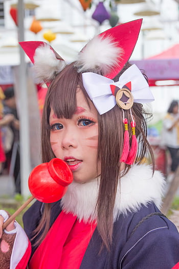 cosplay, cat anime, vibrant costume, festive outdoor, young woman, cat ears, white bow, red tassels, anime character, cosplay event, portrait