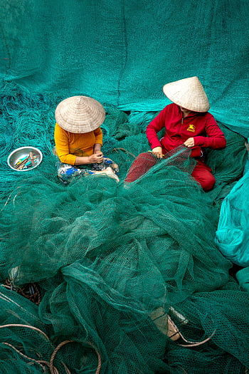 fishing nets, workers repairing, traditional attire, vibrant colors, Vietnam fishermen, conical hats, green nets, fishing industry, cultural practices, net mending, fishing communities