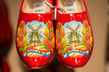 Dutch wooden shoes, red ceramic shoes, windmill design, tulips design, traditional Dutch, close-up, Holland, wooden clogs, Dutch culture, Dutch souvenirs, Dutch footwear