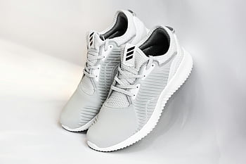 sneakers, dense surface, gray background, sleek white sneakers, white backdrop, athletic shoes, sport footwear, fashion footwear, casual shoes, modern sneakers, minimalist design