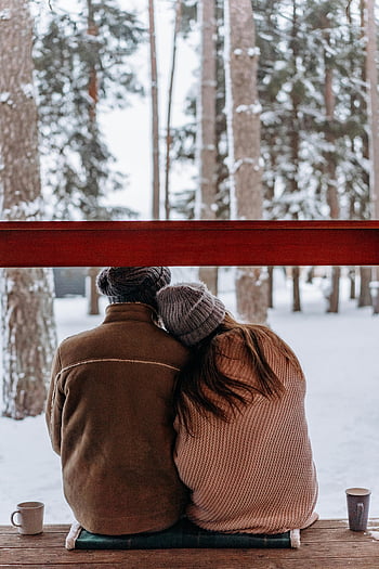 couple photos, winter landscape, cozy scene, snowy forest, winter attire, hot drink, romantic pic, togetherness, outdoor seating, winter season, couple outdoors