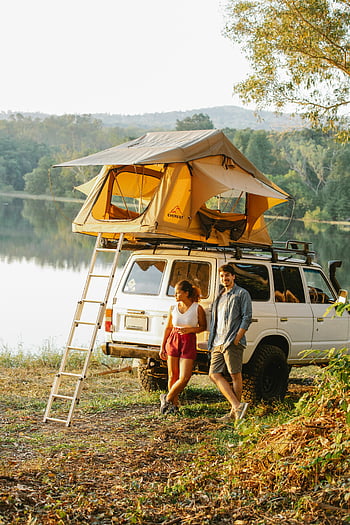 Multiracial par, Lakeside camping, tag telt, bil camping, tur, Fredelig camping, ungt par, udsigt over søen, udendørs eventyr, biltagtelt, Naturcamping