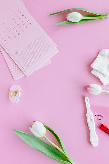 carte rosa, tulipani bianchi, superficie rosa, BABY Essentials, Test di gravidanza positivo, nuova vita, distesa piatta, calzini del bambino, pacificatore, Annuncio di gravidanza, Prossimamente