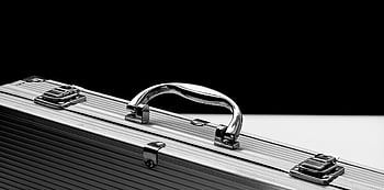 silver suitcase, metal briefcase, shiny chrome handle, black and white background, close-up, sturdy metal, chrome handle, briefcase, suitcase, luggage, travel case