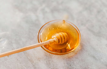 honey dripper, glass bowl, golden honey, close-up shot, honey spoon, honey dipper, sweet honey, honey bowl, honey close-up, honey dipper spoon, honey in bowl