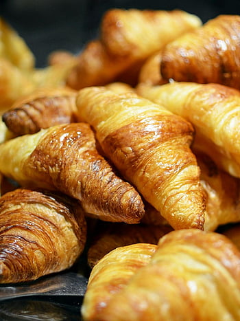 croissants, freshly baked, golden croissants, flaky layers, bakery setting, stack of croissants, pastry, baked goods, breakfast, French pastry, golden brown